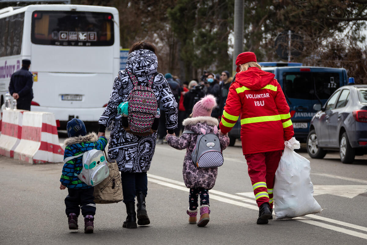 Famiglia con bambini assistita da una volontaria